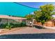 Backyard featuring a garden, shade sail, and pool ladder, perfect for outdoor enjoyment and relaxation at 557 S Lemon Ct, Gilbert, AZ 85296