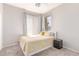 A cozy bedroom with a single bed, side table, and natural light streaming through the windows at 557 S Lemon Ct, Gilbert, AZ 85296