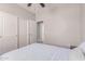 Bedroom with white trim, carpeted floor, ceiling fan, and a closet at 557 S Lemon Ct, Gilbert, AZ 85296