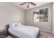 Bedroom with a queen sized bed, ceiling fan, and natural light from a window at 557 S Lemon Ct, Gilbert, AZ 85296