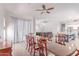Bright dining area with a dining table, hardwood floors, and view into the open concept living and kitchen spaces at 557 S Lemon Ct, Gilbert, AZ 85296