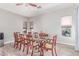 Formal dining room features a large wooden table, elegant chairs, and abundant natural light at 557 S Lemon Ct, Gilbert, AZ 85296