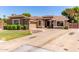 Charming single-story home with a well-maintained lawn, complemented by desert landscaping and a spacious driveway at 557 S Lemon Ct, Gilbert, AZ 85296