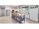 Spacious kitchen features white cabinets, stainless appliances, kitchen island with breakfast bar and light wood floors at 557 S Lemon Ct, Gilbert, AZ 85296