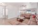 Open-concept living room showcases hardwood floors, a cozy sectional, and seamless transition to the modern kitchen at 557 S Lemon Ct, Gilbert, AZ 85296
