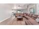 Expansive living room boasts hardwood floors, a plush sectional sofa, and an open layout leading into the kitchen at 557 S Lemon Ct, Gilbert, AZ 85296