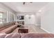 Comfortable living room features a sectional, entertainment center, hardwood flooring, and a compass on the wall at 557 S Lemon Ct, Gilbert, AZ 85296