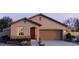 Charming single-story home with a well-manicured front yard and a two-car garage at 5609 S 253Rd Ave, Buckeye, AZ 85326
