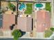 Aerial view of backyard featuring a pool with rock waterfall, patio, grassy area, and desert landscaping at 5744 E Jacaranda St, Mesa, AZ 85205