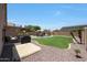 Well-maintained backyard features a sparkling pool, covered patio, and green grass at 5744 E Jacaranda St, Mesa, AZ 85205