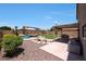 Expansive backyard features a custom pool, lush landscaping, and inviting patio at 5744 E Jacaranda St, Mesa, AZ 85205