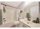 Clean bathroom with a shower-tub combination, black hardware, and ample vanity storage space at 5744 E Jacaranda St, Mesa, AZ 85205