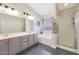 A spacious bathroom featuring dual sinks, a soaking tub, and a walk-in shower at 5744 E Jacaranda St, Mesa, AZ 85205