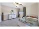 Inviting bedroom with themed bedding, grey dresser, and ample natural light creating a cozy space at 5744 E Jacaranda St, Mesa, AZ 85205