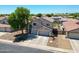Inviting two-story home with a three-car garage and desert landscaping at 5744 E Jacaranda St, Mesa, AZ 85205