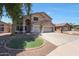 A two-story home with a three-car garage, landscaped front yard, and neutral colored paint at 5744 E Jacaranda St, Mesa, AZ 85205