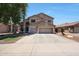 A two-story home with a three-car garage, landscaped front yard, and neutral colored paint at 5744 E Jacaranda St, Mesa, AZ 85205