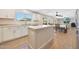 Stylish kitchen featuring white cabinets, an island, and open access to dining and living spaces at 5744 E Jacaranda St, Mesa, AZ 85205