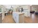 Well-lit kitchen with white cabinets, center island, and open access to the dining and living areas at 5744 E Jacaranda St, Mesa, AZ 85205