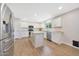 Modern kitchen featuring white cabinetry, stainless steel appliances, and a convenient center island at 5744 E Jacaranda St, Mesa, AZ 85205