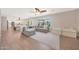 Open-concept living room with wood floors, large couch, and well-lit dining area at 5744 E Jacaranda St, Mesa, AZ 85205