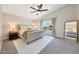 Bright main bedroom features plush carpet, ensuite bathroom, and a king bed at 5744 E Jacaranda St, Mesa, AZ 85205