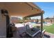 Covered patio with string lights, lounge seating, and beautiful pool view at 5744 E Jacaranda St, Mesa, AZ 85205
