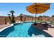 Inviting backyard pool with a rock waterfall, lounge chairs and lush landscaping at 5744 E Jacaranda St, Mesa, AZ 85205