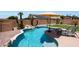 Backyard pool featuring a waterfall, lounge chairs and lush landscaping at 5744 E Jacaranda St, Mesa, AZ 85205