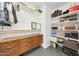 A large walk-in closet featuring custom shelving and a mid-century modern dresser at 5744 E Jacaranda St, Mesa, AZ 85205
