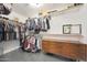 A large walk-in closet featuring custom shelving and a mid-century modern dresser at 5744 E Jacaranda St, Mesa, AZ 85205