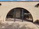 Arched gate entrance to the courtyard featuring benches and decorative ironwork at 5801 N 73Rd Ave, Glendale, AZ 85303