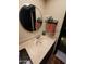 Bathroom vanity featuring a stylish sink, round mirror, and modern fixtures at 5801 N 73Rd Ave, Glendale, AZ 85303