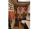 Full bathroom with patterned shower curtain, tile flooring, and coordinated towels at 5801 N 73Rd Ave, Glendale, AZ 85303