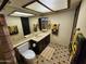 Full bathroom with sunflower shower curtain, functional vanity, and neutral decor at 5801 N 73Rd Ave, Glendale, AZ 85303