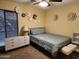 Inviting bedroom with a cozy bed, stylish dresser, and unique floral wall decor at 5801 N 73Rd Ave, Glendale, AZ 85303