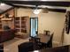 Dining area adjacent to the living room with wood table and chairs, and brick fireplace at 5801 N 73Rd Ave, Glendale, AZ 85303