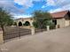 Beautiful home with a brick facade, arched entryways, and an expansive paved driveway at 5801 N 73Rd Ave, Glendale, AZ 85303
