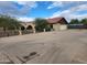 Spacious home with a brick facade, arched entryways, two-car garage and an expansive paved driveway at 5801 N 73Rd Ave, Glendale, AZ 85303