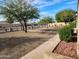 Well-maintained front yard with desert landscaping, including mature trees and cacti at 5801 N 73Rd Ave, Glendale, AZ 85303