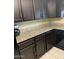 Kitchen featuring dark wood cabinets, granite countertops, and modern appliances at 5801 N 73Rd Ave, Glendale, AZ 85303