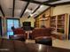 Open living room with brick fireplace, beamed ceilings, and leather seating at 5801 N 73Rd Ave, Glendale, AZ 85303