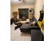 Modern living room with sectional sofa, unique coffee table, and Pac-Personal arcade game at 5801 N 73Rd Ave, Glendale, AZ 85303