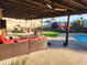 Inviting covered patio with comfortable seating, poolside views, and a desert-themed mural backdrop at 5801 N 73Rd Ave, Glendale, AZ 85303