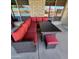 Stylish outdoor seating area featuring a wicker sectional, dining table, and red cushioned seating at 5801 N 73Rd Ave, Glendale, AZ 85303