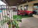 Charming patio area with brick siding, ceiling fans, outdoor furniture, and faux grass at 5801 N 73Rd Ave, Glendale, AZ 85303