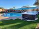 Beautiful backyard with a swimming pool, hot tub, desert mural, and artificial grass at 5801 N 73Rd Ave, Glendale, AZ 85303