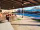 Relaxing backyard with pool, covered patio, outdoor seating, and desert mural at 5801 N 73Rd Ave, Glendale, AZ 85303
