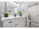 Modern bathroom featuring a white vanity with marble countertop, sleek black hardware, and neutral paint at 5813 W Gelding Dr, Glendale, AZ 85306