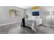 Bright bedroom with a large window, gray vinyl flooring, and modern decor at 5813 W Gelding Dr, Glendale, AZ 85306